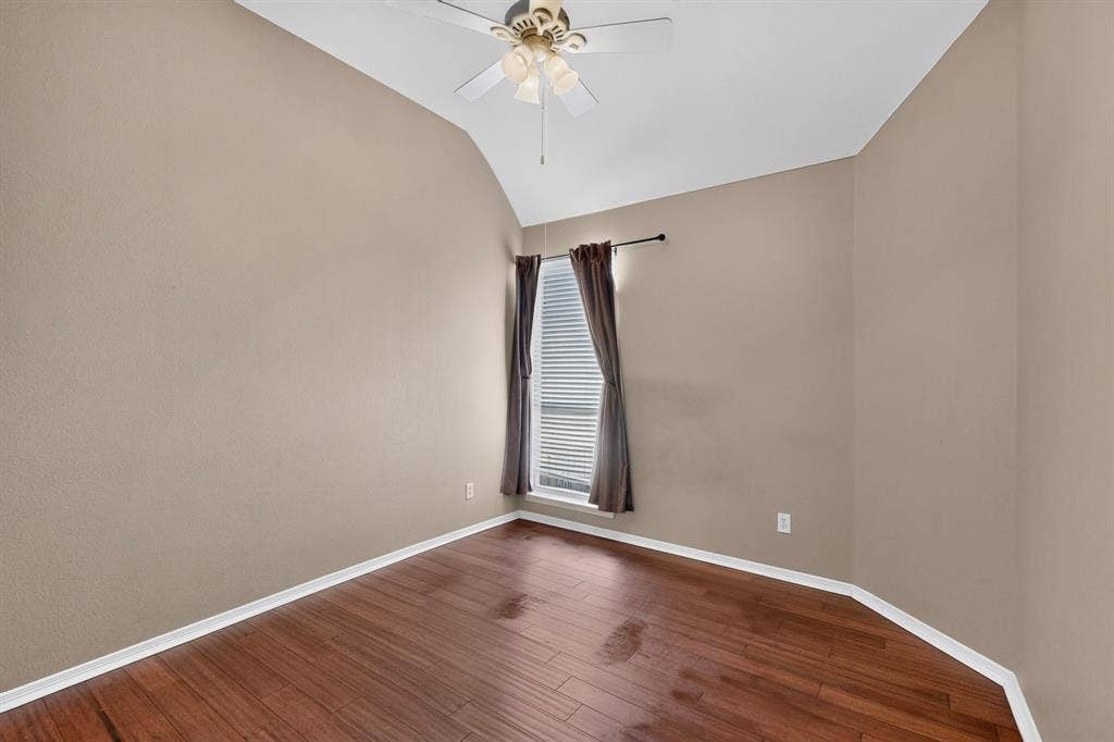 713 Mockingbird Court, Crowley, TX 76036 Vaulted ceiling with a ceiling fan, wood-finish flooring, and natural light