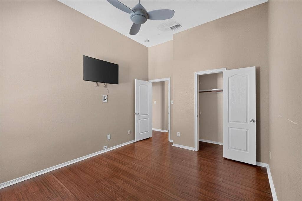 713 Mockingbird Court, Crowley, TX 76036 Wood-finish flooring, vaulted ceilings, ceiling fan, white interior doors, and built-in closet shelving