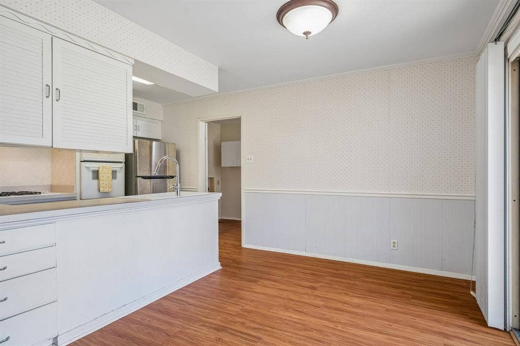 902 N Lindale Lane, Richardson, TX 75080 Warm wood toned flooring provides a homey feel throughout the dining, kitchen, and utility areas.