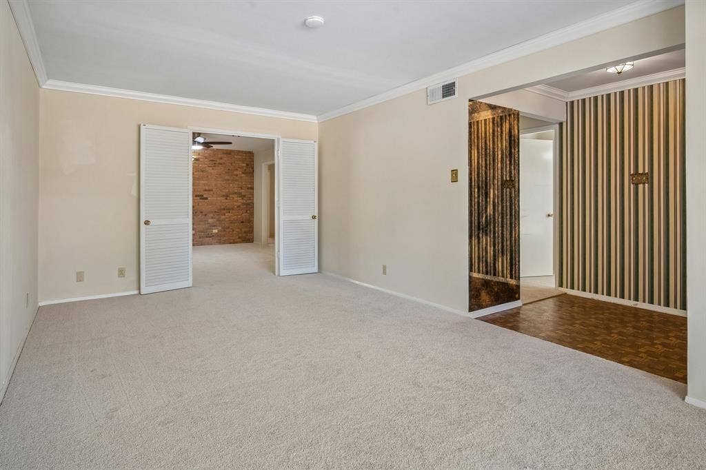 902 N Lindale Lane, Richardson, TX 75080 Crown molding adds architectural detail and a formal feel to this front living space.