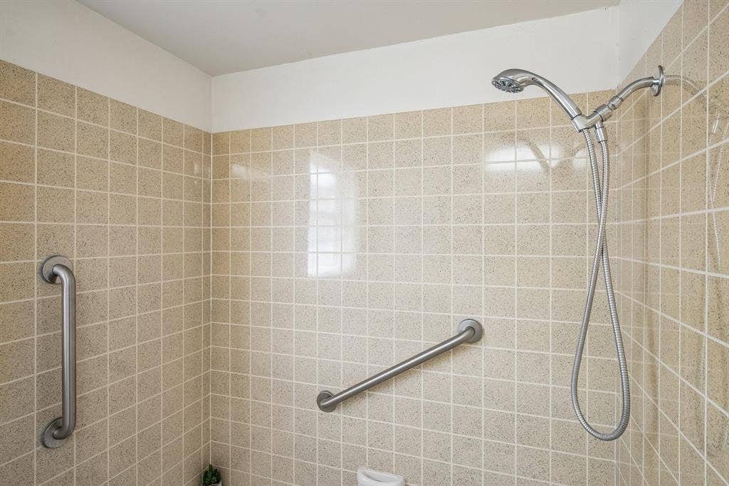 902 N Lindale Lane, Richardson, TX 75080 Earthy vintage tile accompanies the hall bath.