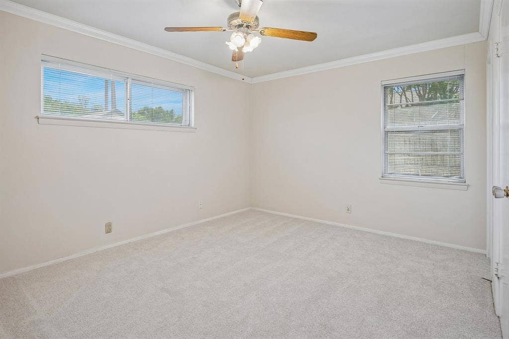 902 N Lindale Lane, Richardson, TX 75080 Retreat to the primary bedroom, equipped with an ensuite bathroom.