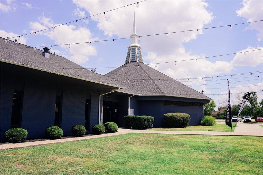2705 Virginia Parkway, McKinney, TX 75071 Building exterior featuring a steeple, dark shingle roof, and dark siding