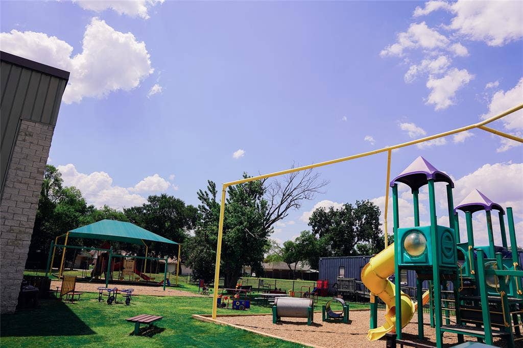 2705 Virginia Parkway, McKinney, TX 75071 Community Recreation Area featuring a multi-level playground with dual slide towers, elevated observation decks, and bright yellow slide chutes
