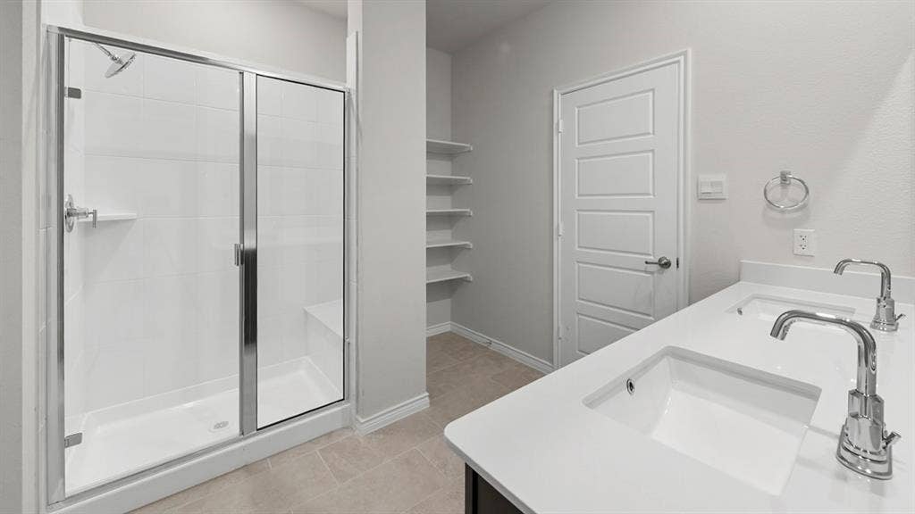 8425 Everly Drive, Garland, TX 75043 Dual vanity with integrated sinks and chrome fixtures, featuring a white countertop