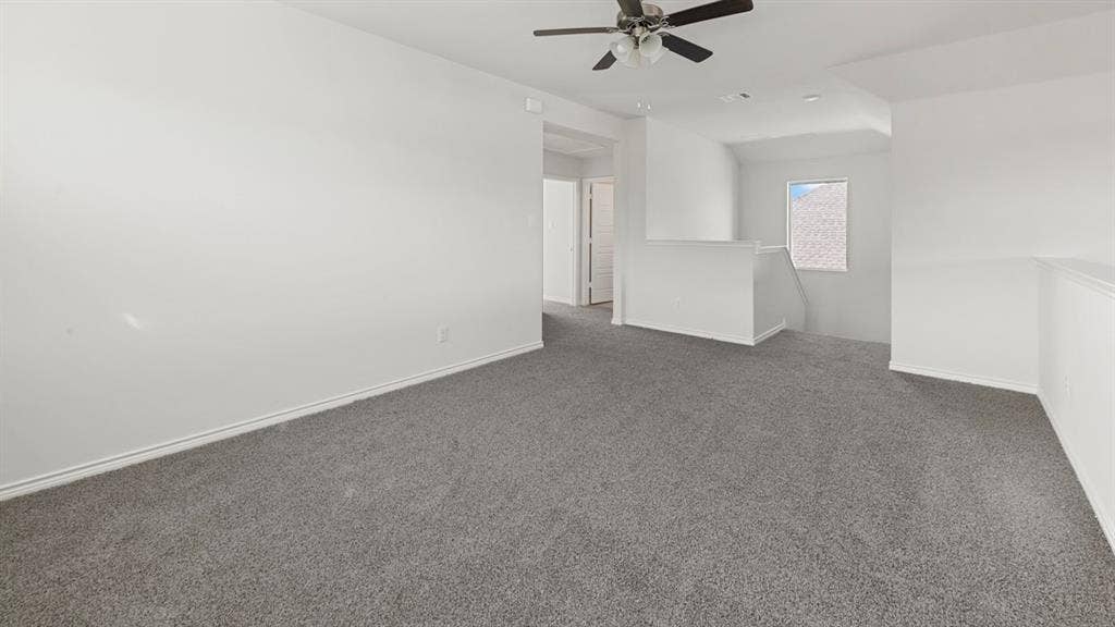 8425 Everly Drive, Garland, TX 75043 Spacious interior featuring neutral wall finishes, gray carpeting throughout, and a ceiling fan