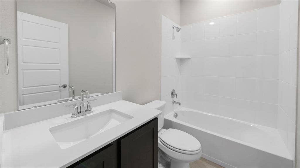 8425 Everly Drive, Garland, TX 75043 Modern bathroom featuring a sleek vanity with an integrated rectangular sink, white quartz countertop, and chrome faucet hardware