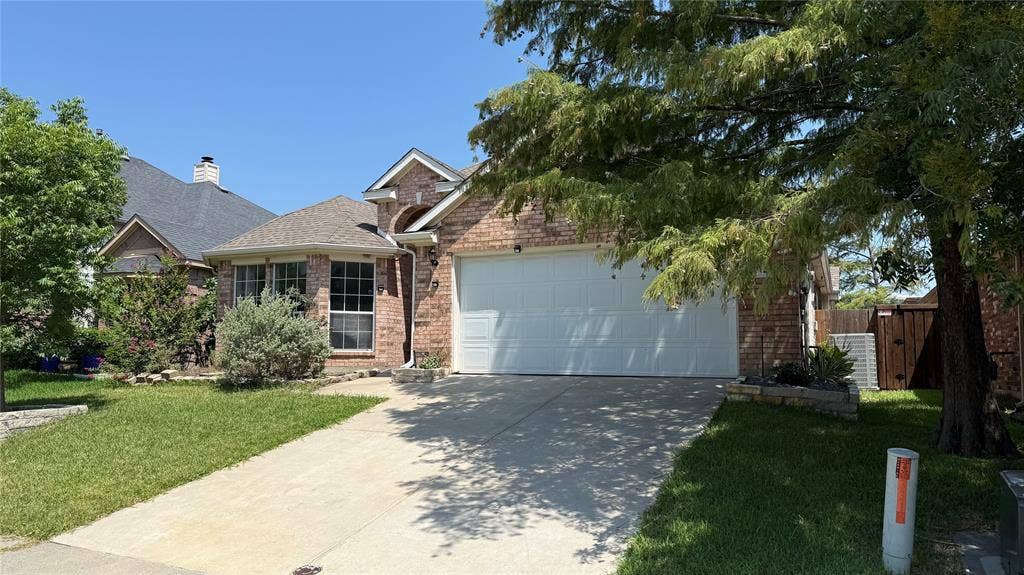 3312 Woodberry Lane, McKinney, TX 75071 Traditional brick facade with an attached two-car garage