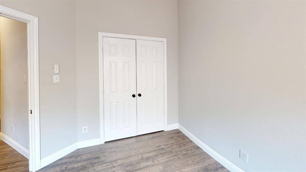 3312 Woodberry Lane, McKinney, TX 75071 Interior space featuring light gray walls, wood-finish flooring, and white baseboards