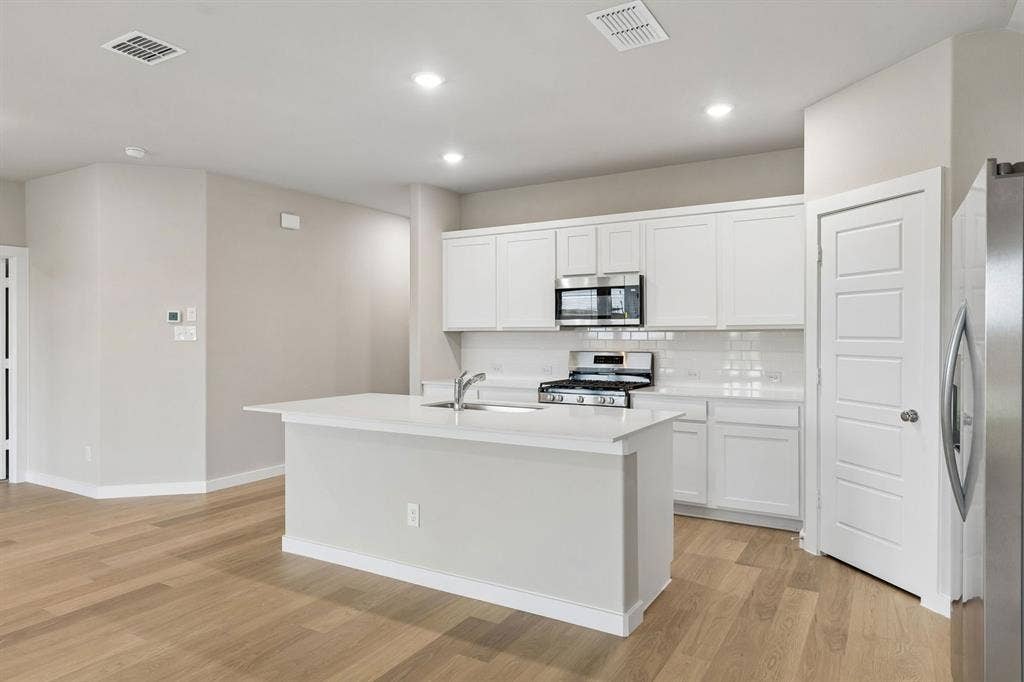 2214 Willowbank Drive, Forney, TX 75126 Kitchen in the Emmy II home plan by Trophy Signature Homes - REPRESENTATIVE PHOTO