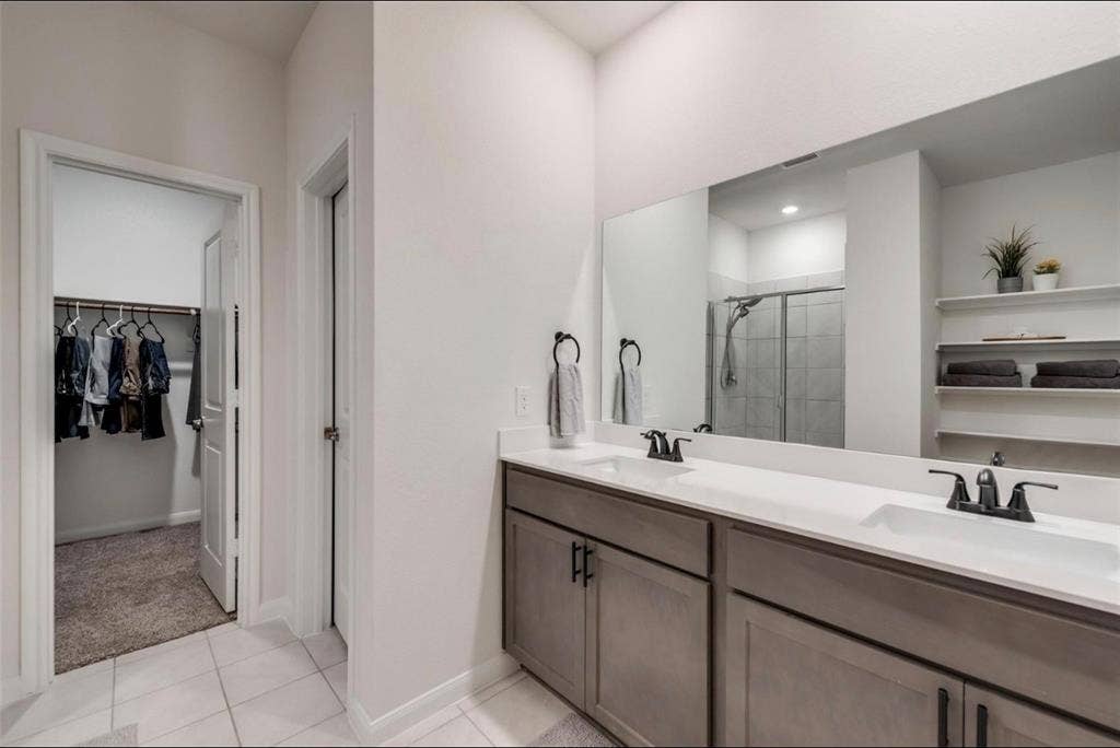 902 Western Way, Princeton, TX 75407 Dual vanity with undermount sinks, stone-finish countertop, and matte black fixtures