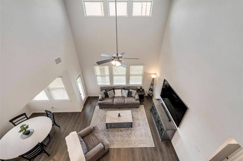 902 Western Way, Princeton, TX 75407 Vaulted ceiling with multiple windows and a ceiling fan