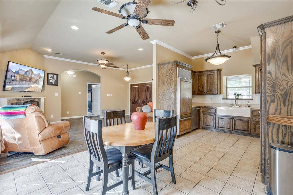 220 Royal Court, Weatherford, TX 76085 dining area is open to the living room with a view of the fireplace and pool