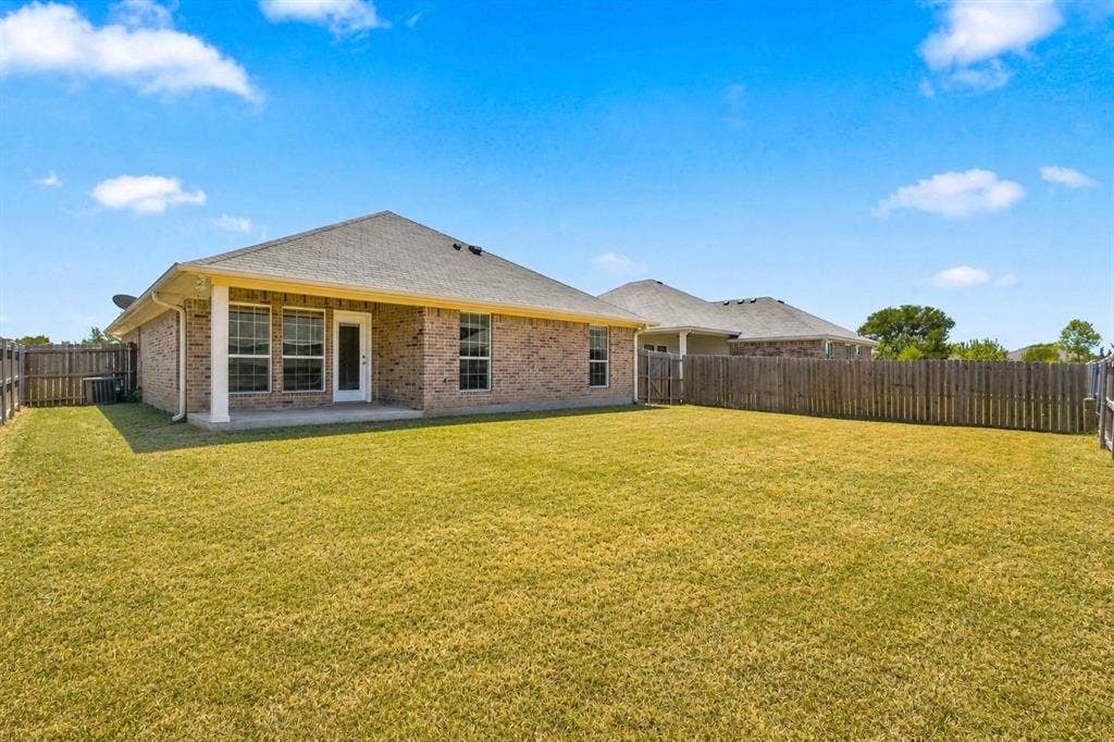 204 Raven Ridge Court, Lacy Lakeview, TX 76705 Brick exterior with elegant architectural detailing, large multi-pane windows, and a covered entry
