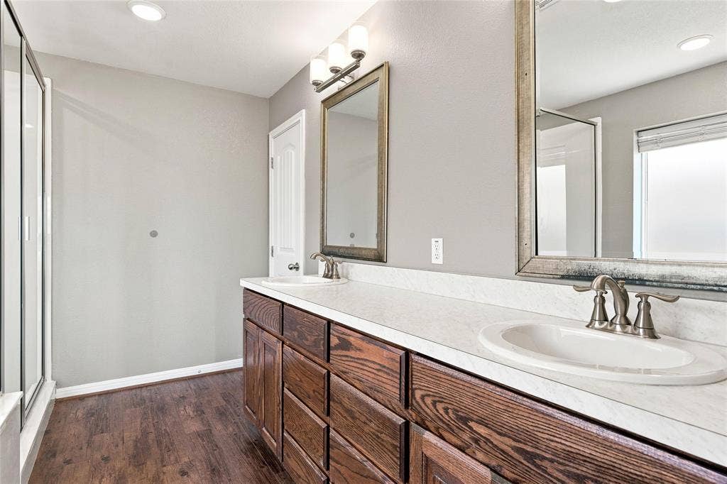 204 Raven Ridge Court, Lacy Lakeview, TX 76705 Dual vanity with wood-finish cabinetry, white countertops, and undermount sinks