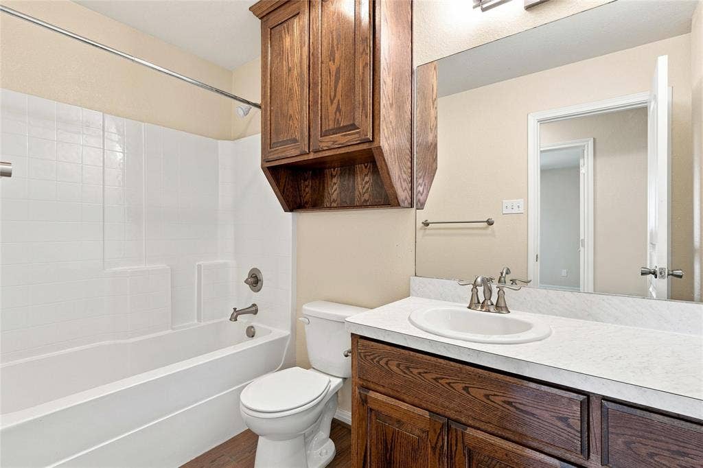 204 Raven Ridge Court, Lacy Lakeview, TX 76705 Bathroom with a vanity featuring a wood-finish cabinet, a white countertop with an integrated sink, and a large mirror