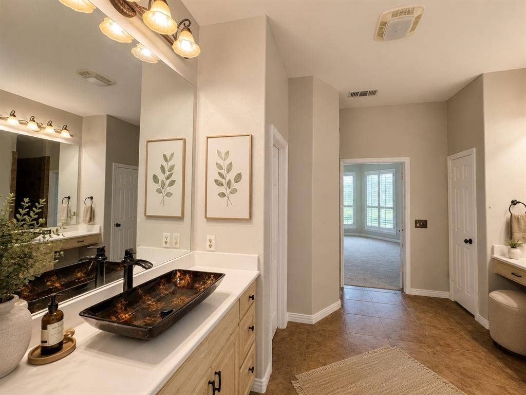 Spacious bathroom vanity featuring a rectangular vessel sink with a dark finish, white countertop, wood-finish cabinetry, and a multi-bulb vanity light fixture