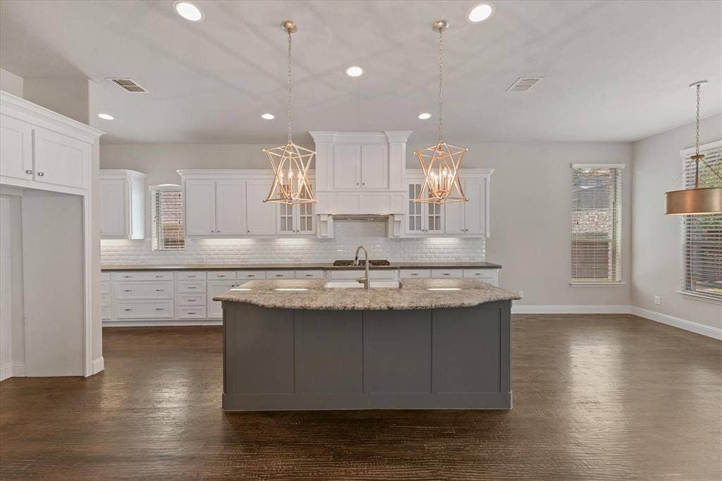 10846 Smoky Oak Trail, Argyle, TX 76226 The home features fresh paint throughout on every surface of the 4,971 sq ft home! (walls, ceiling, doors, trim, baseboards, molding, cabinets, etc) It shines like new! This entire home has been refreshed with even new carpet on the upper level too! First floor showcases hand scraped hardwood floors. Kitchen features built in SS appliances, a gas cooktop, tons of storage, granite and quartz countertops, a deep farmhouse sink, gorgeous lighting fixtures, an island with room for barstools, eat in kitchen, open floor plan, and more!