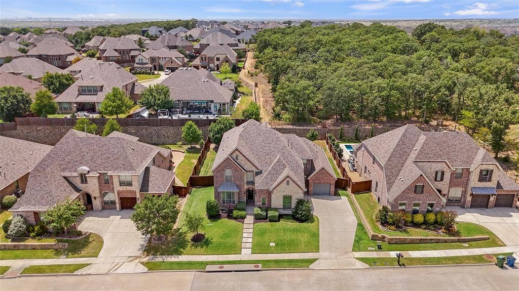 10846 Smoky Oak Trail, Argyle, TX 76226 This gorgeous almost 5,000 sqft home features a 3 car garage, a gorgeous brick and stone elevation, over a quarter acre lot that backs up to a quiet greenbelt for extra privacy, and the perfect layout with two of the five bedrooms on the first floor, as well as a dedicated office!