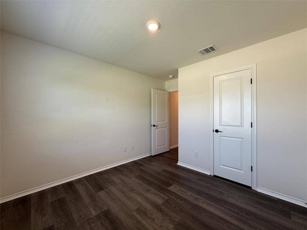 2702 Marotto Way, Seagoville, TX 75159 Room featuring wood-finish flooring, white baseboards, and neutral wall paint
