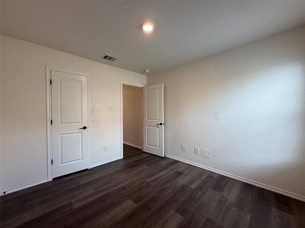 2702 Marotto Way, Seagoville, TX 75159 Room featuring wood-finish flooring, white baseboards, and neutral wall paint