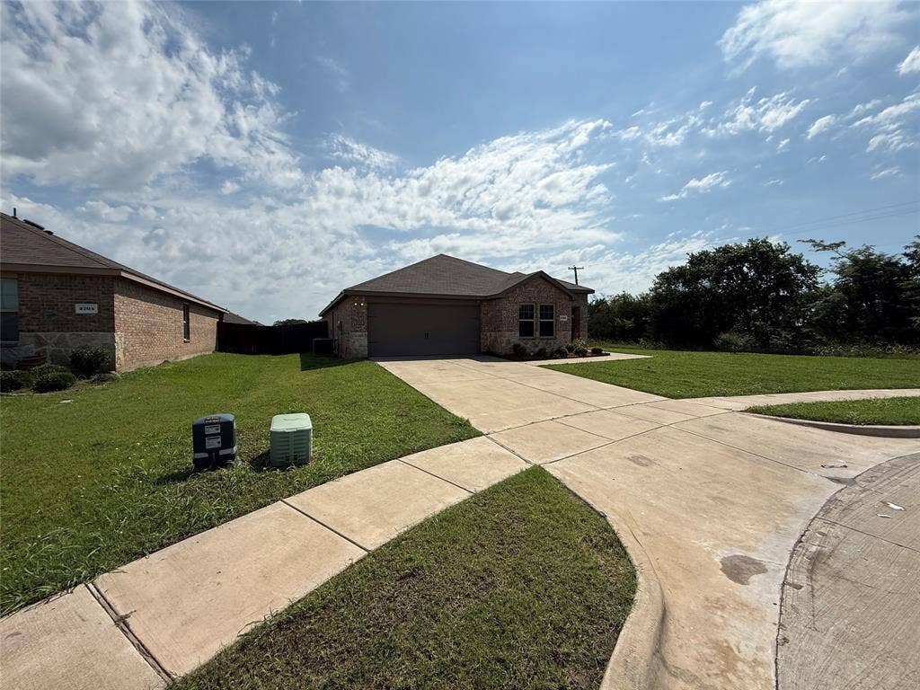 2702 Marotto Way, Seagoville, TX 75159 Single-story residence featuring a brick and stone facade, an attached garage, and a concrete driveway