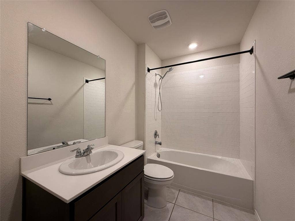 2702 Marotto Way, Seagoville, TX 75159 Bathroom featuring a dark wood-finish vanity with an oval undermount sink, a white countertop, and a large wall-mounted mirror