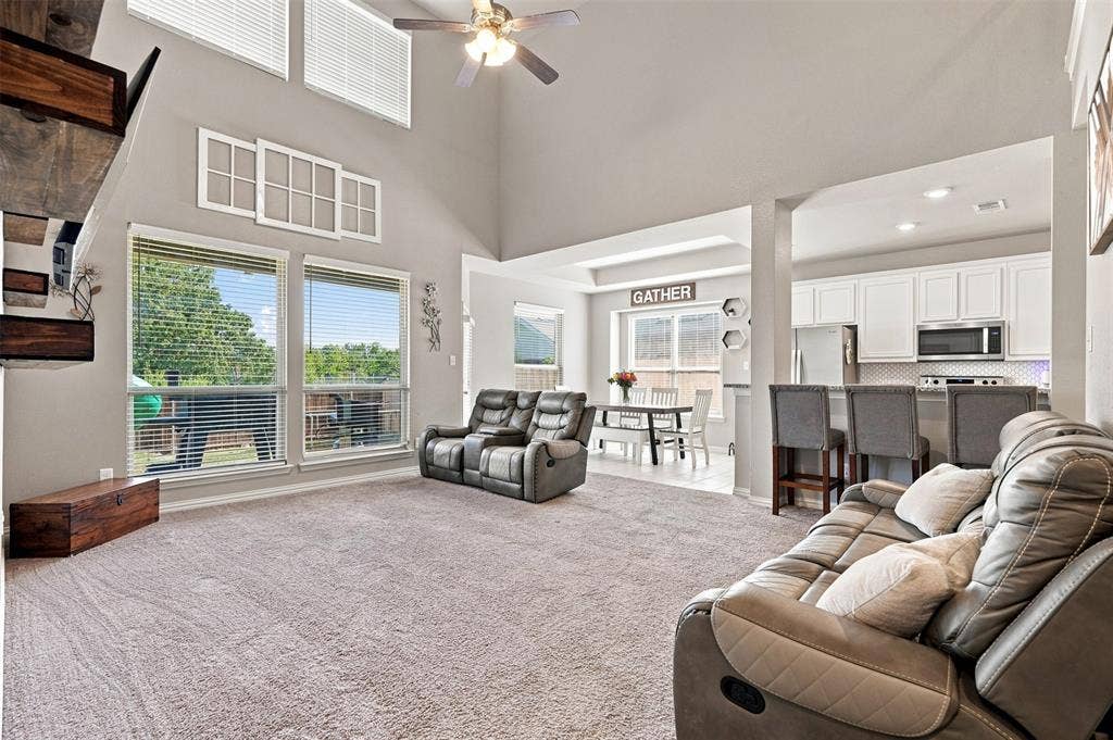 Spacious living area featuring a vaulted ceiling and an open-concept design
