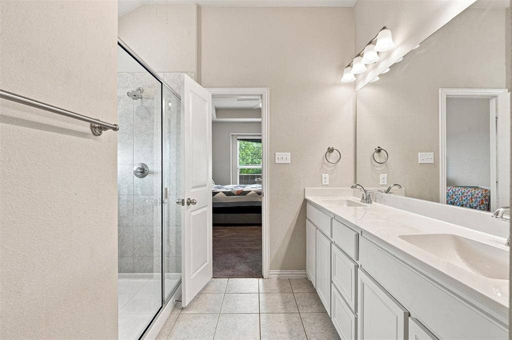 Double vanity with light-toned countertop, dual sinks, and polished chrome fixtures