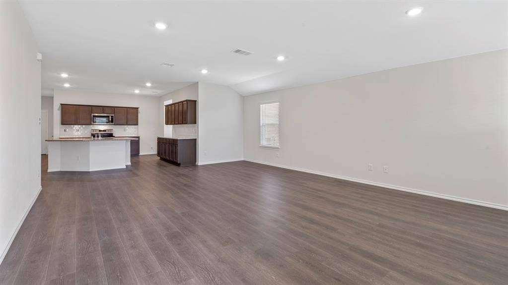 401 Banner Avenue, Royse City, TX 75189 Open-concept living area with wood-finish flooring and recessed lighting