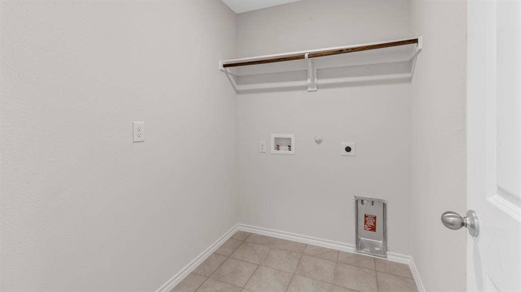 401 Banner Avenue, Royse City, TX 75189 Utility closet featuring tile flooring, neutral wall paint, and a built-in clothing rod with shelving