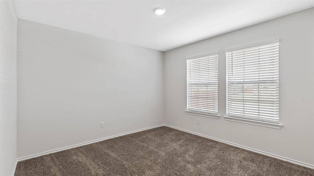 401 Banner Avenue, Royse City, TX 75189 Neutral wall tones complement the durable carpet flooring