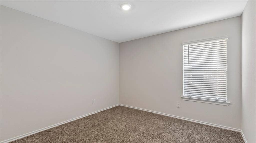 401 Banner Avenue, Royse City, TX 75189 Neutral-toned room featuring a single window with blinds, recessed ceiling lighting, light gray walls, and brown carpet flooring