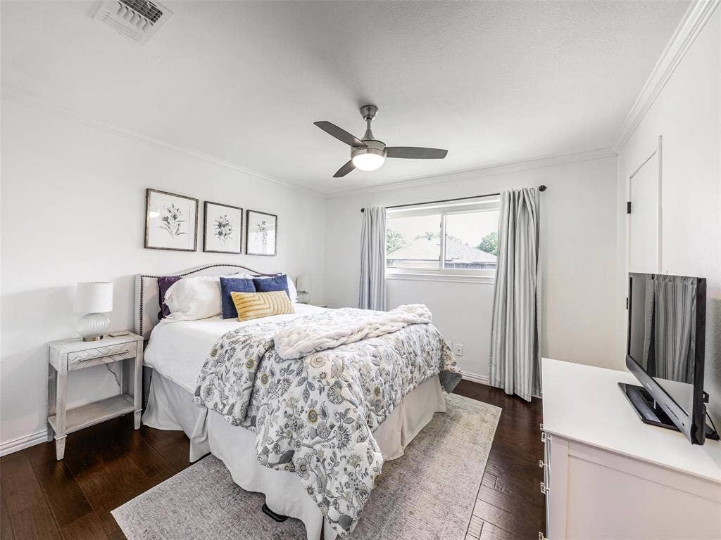 3617 Hackamore Court, Plano, TX 75023 Bright bedroom featuring wood-finish flooring, a ceiling fan with integrated lighting, window with curtains, and white walls