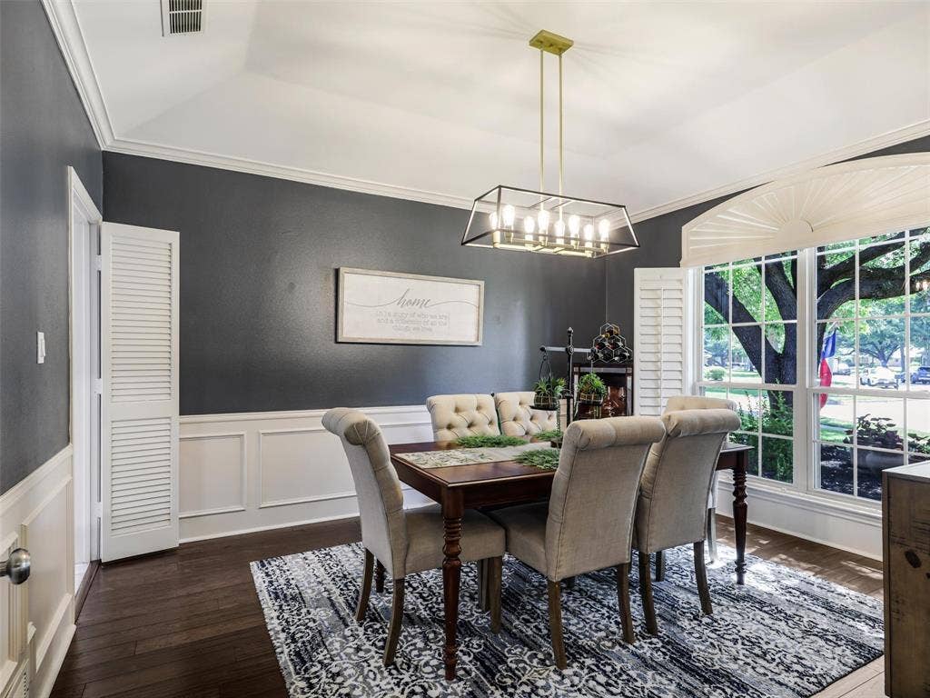 3617 Hackamore Court, Plano, TX 75023 Dining area featuring dark wood-finish flooring, white wainscoting, and a tray ceiling, Can flex into a Study if needed.