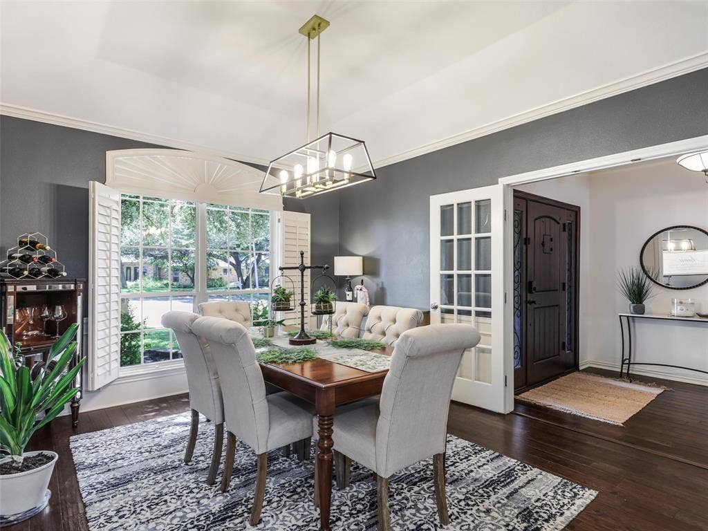 3617 Hackamore Court, Plano, TX 75023 Dining area with dark wood-finish flooring and a contemporary chandelier