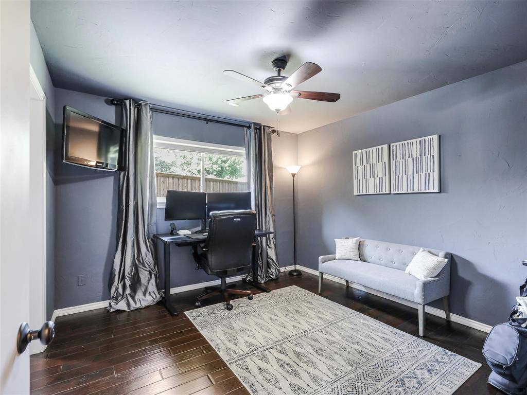 3617 Hackamore Court, Plano, TX 75023 Dark wood-finish flooring complements the neutral wall color in this room featuring a ceiling fan in cozy bedroom.