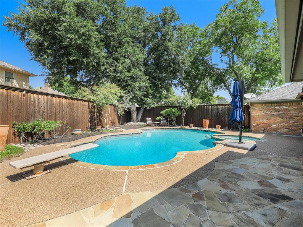 3617 Hackamore Court, Plano, TX 75023 Curved swimming pool with an exposed aggregate concrete deck and a flagstone patio and refreshing spa!
