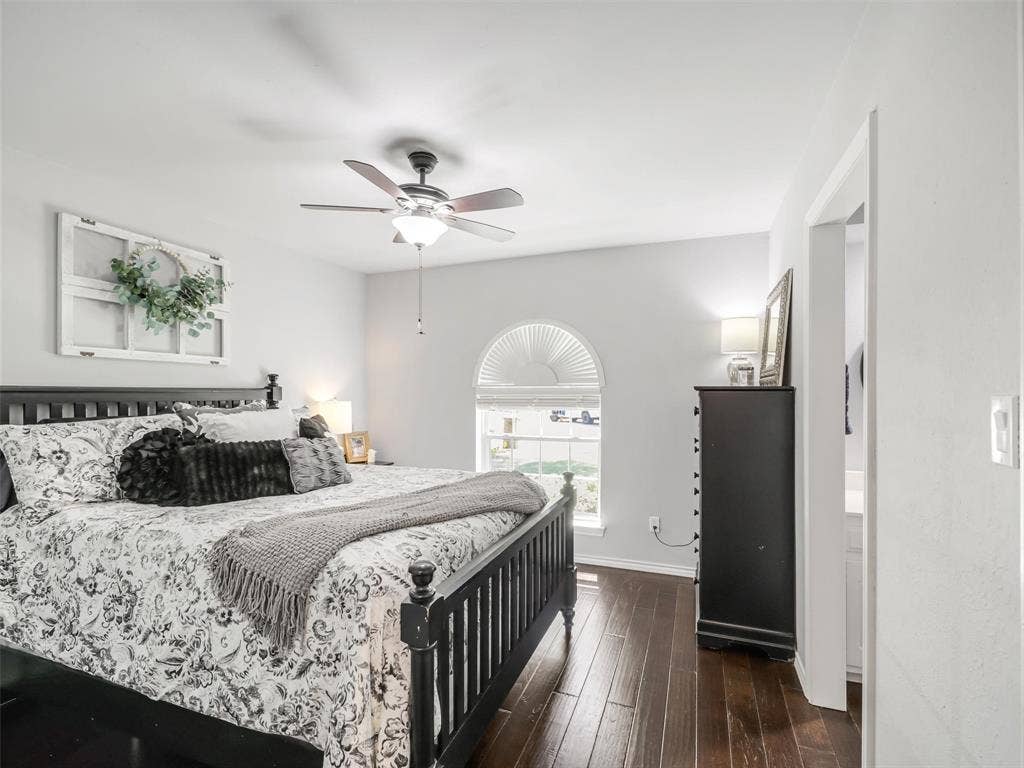 3617 Hackamore Court, Plano, TX 75023 Spacious room featuring rich wood-finish flooring, a ceiling fan with integrated lighting, and a prominent arched window