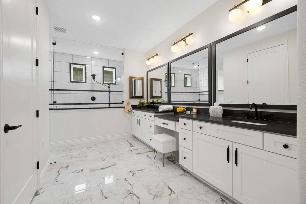 Impactful Primary Bathroom has Dual Sinks and Vanity