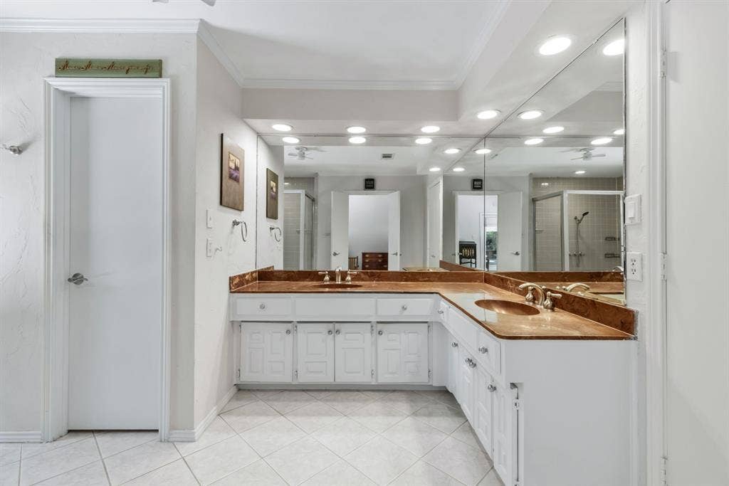 6803 Fernshaw Drive, Dallas, TX 75248 Dual integrated sinks with polished brass fixtures set into a wraparound countertop