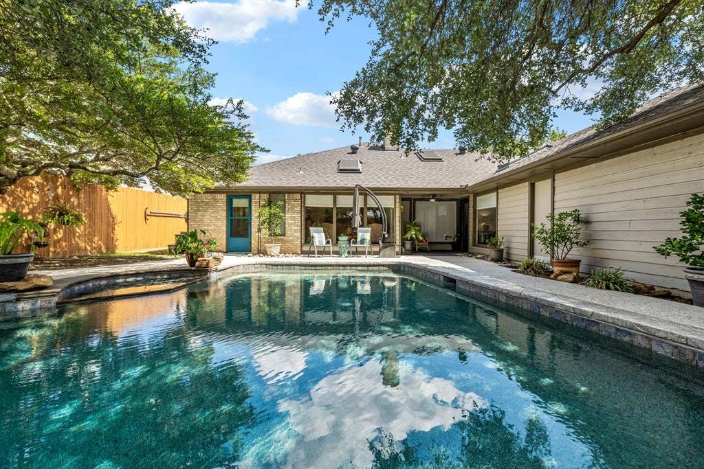 6803 Fernshaw Drive, Dallas, TX 75248 Swimming pool with integrated spa, stone coping, and surrounding concrete decking
