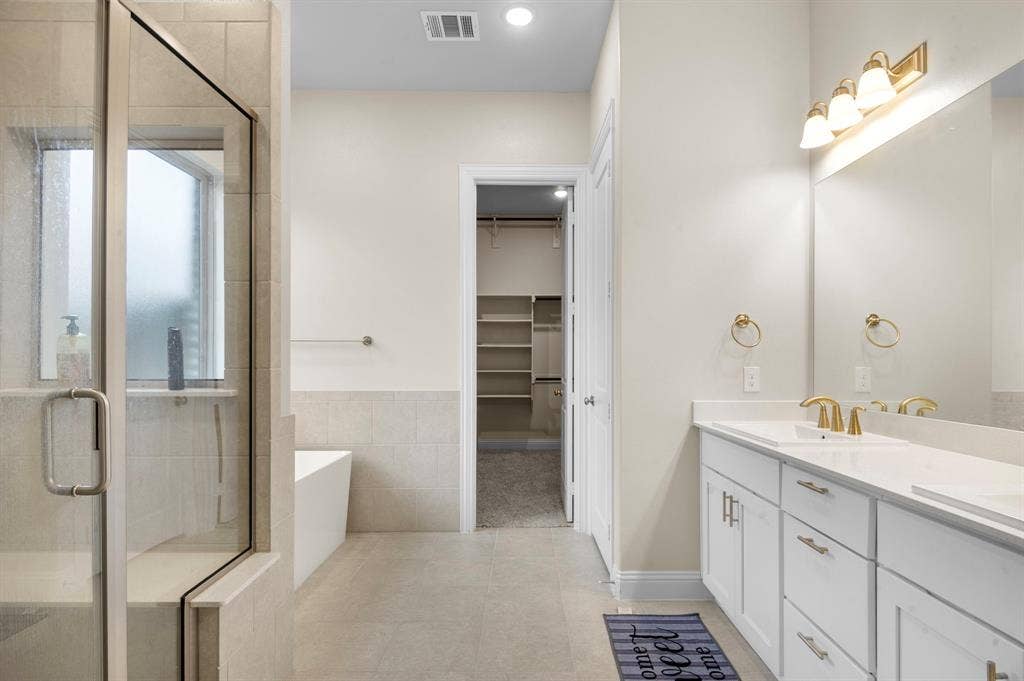 16050 Talamore Lane, Frisco, TX 75035 Bathroom with vanity, tile patterned floors, and shower with separate bathtub