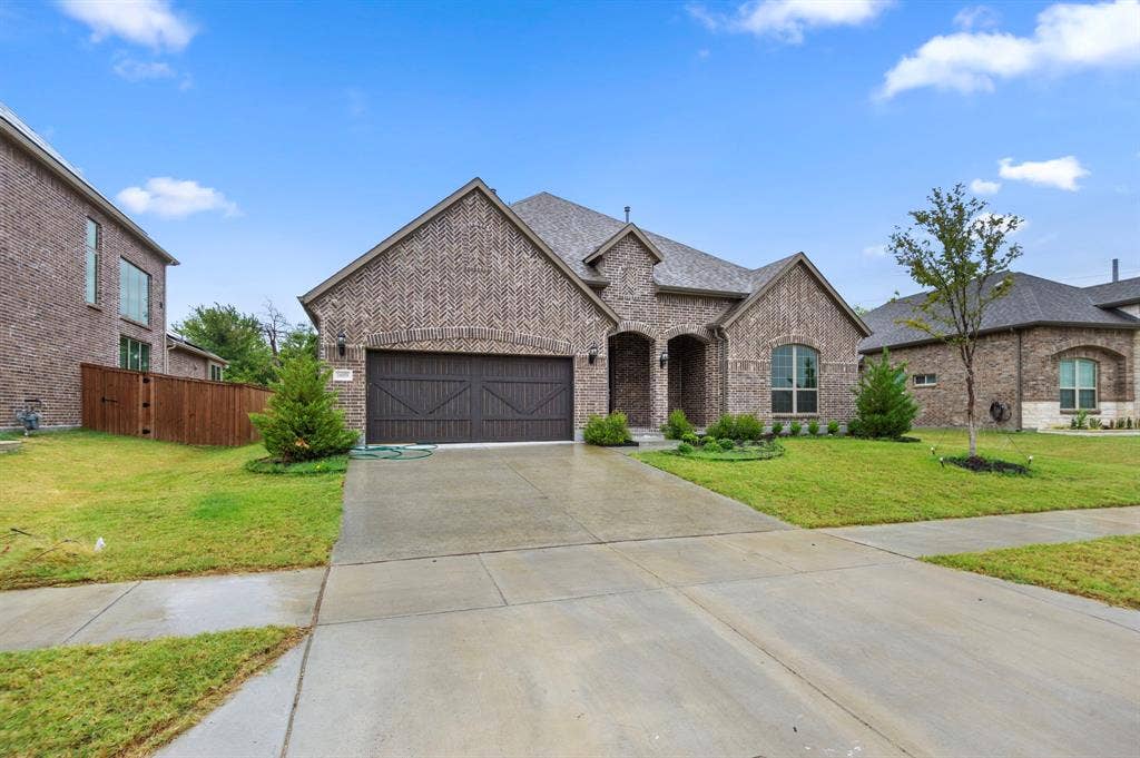 16050 Talamore Lane, Frisco, TX 75035 French country style house featuring a garage and a front yard