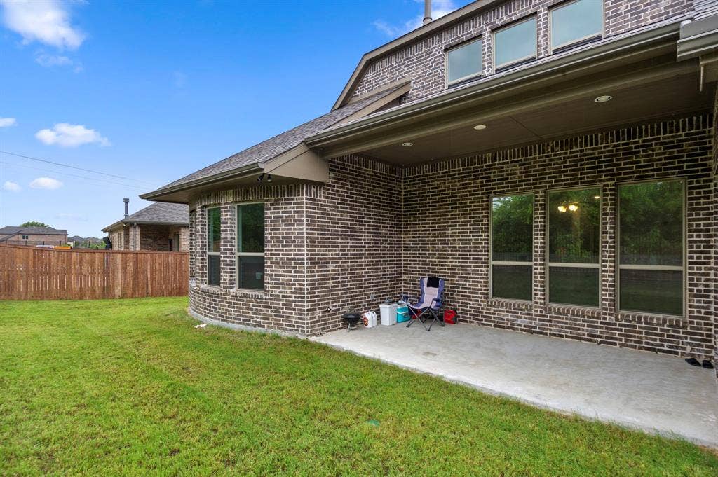 16050 Talamore Lane, Frisco, TX 75035 Rear view of house featuring a lawn and a patio area