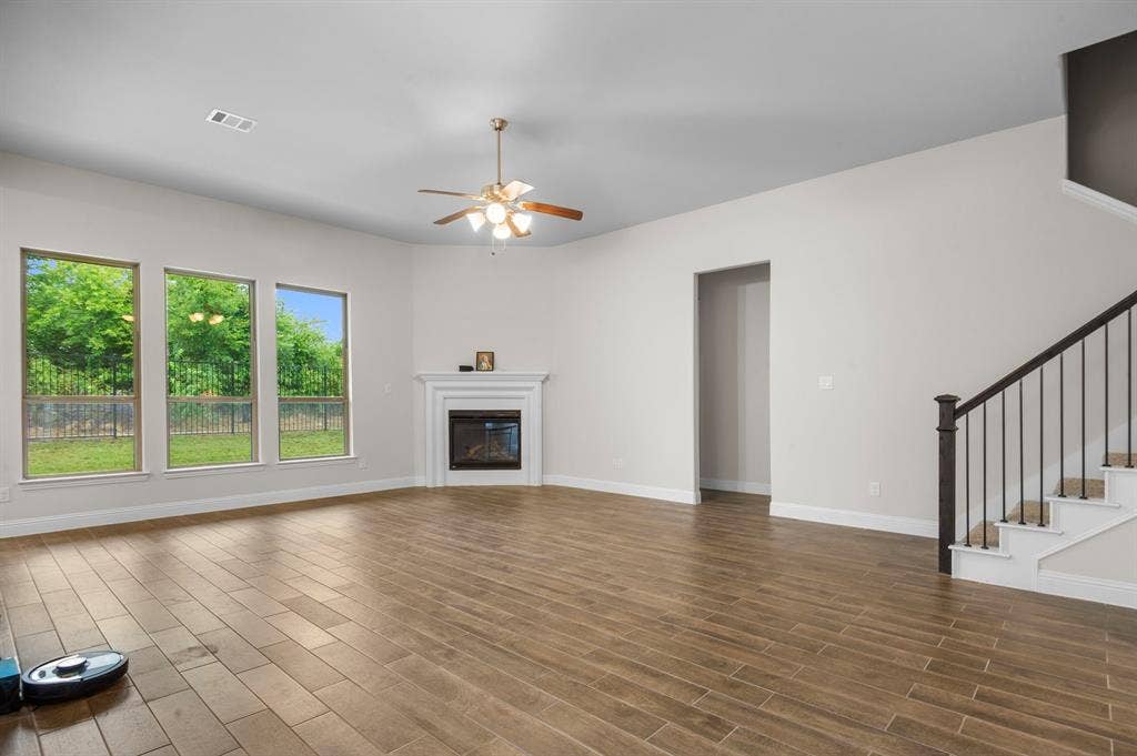 16050 Talamore Lane, Frisco, TX 75035 Unfurnished living room with ceiling fan and dark hardwood / wood-style floors