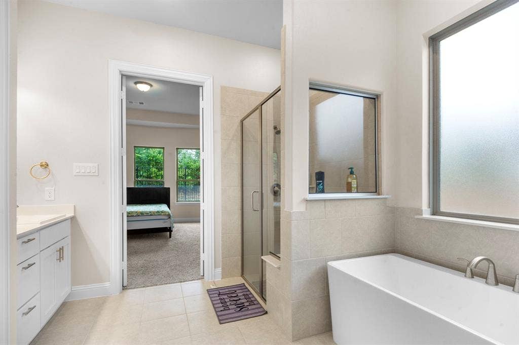 16050 Talamore Lane, Frisco, TX 75035 Bathroom featuring tile patterned flooring, vanity, and independent shower and bath