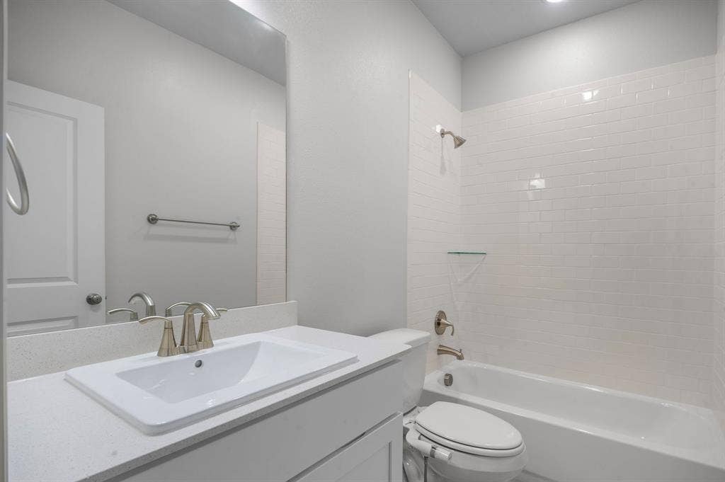 16050 Talamore Lane, Frisco, TX 75035 Full bathroom featuring tiled shower / bath, toilet, and vanity
