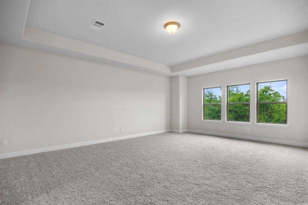 16050 Talamore Lane, Frisco, TX 75035 Carpeted empty room featuring a raised ceiling