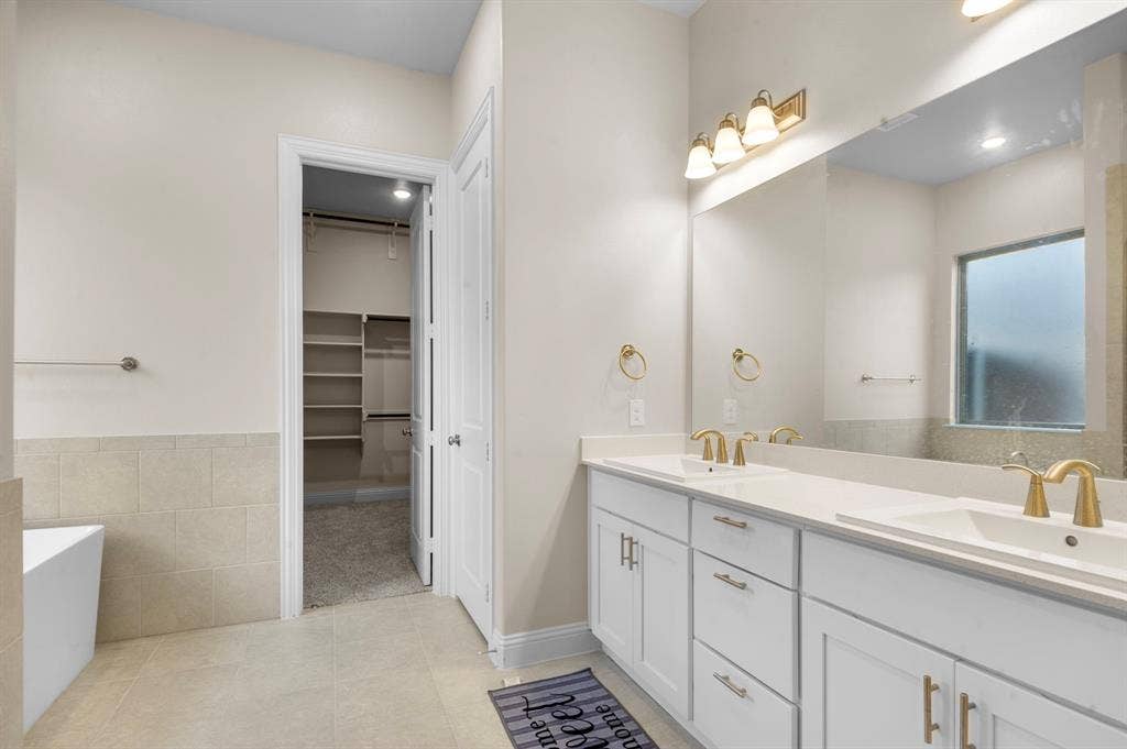 16050 Talamore Lane, Frisco, TX 75035 Bathroom with tile patterned flooring, a bathtub, and vanity